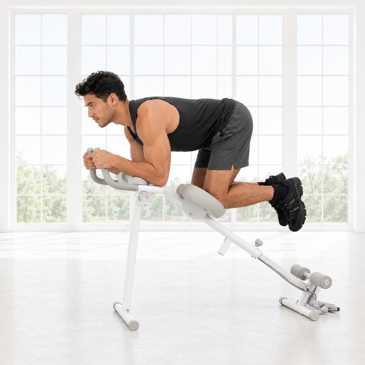 Man in a gray tank top and shorts in a kneeling core position on the white Wonder Core Pro Max 4-in-1 machine in a bright room, demonstrating a 30-day at-home ab workout for office workers